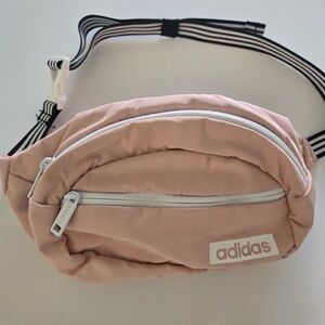 Adidas Core Waist Pack ln Glow Pink with a black and white striped strap.